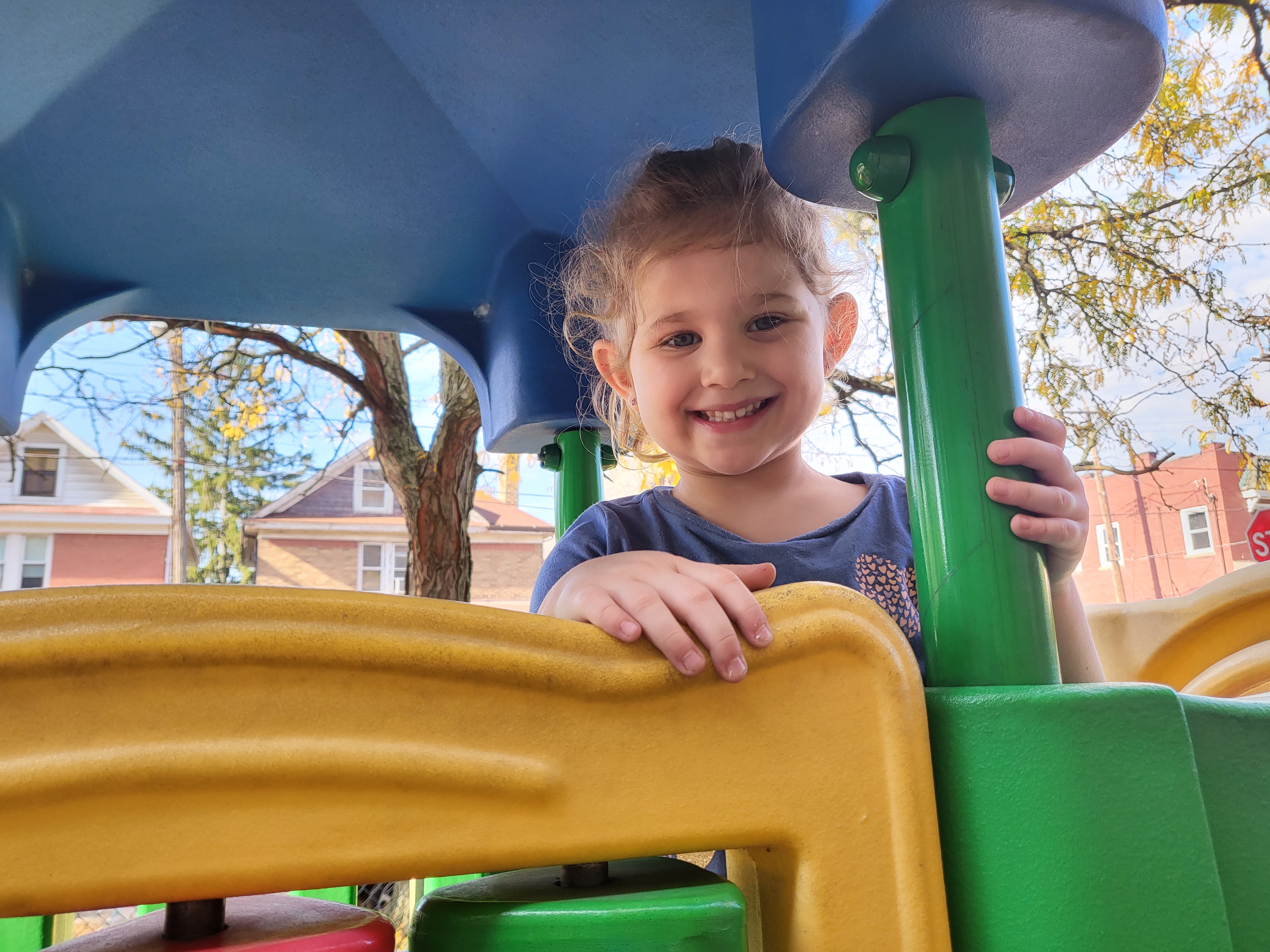 Preschool child playing on playground equipment