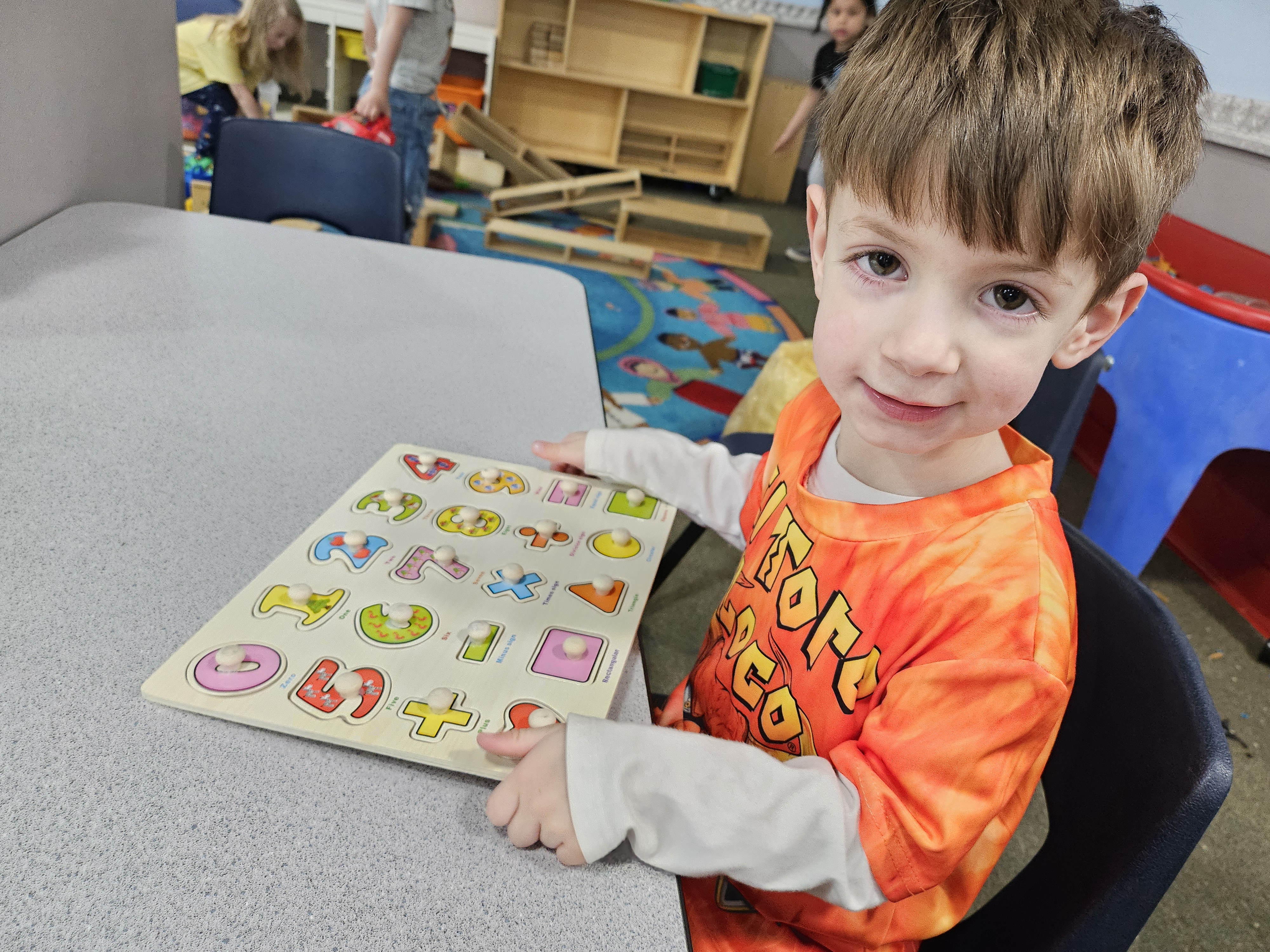 Preschool child proudly finishing an activity