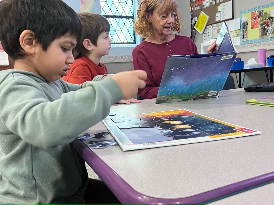 Preschool child working on a puzzle